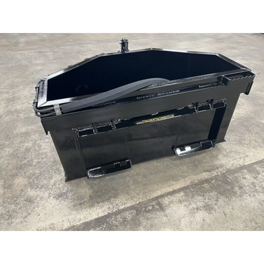 Black steel concrete bucket skid steer attachment with angled sides and reinforced mounting brackets on concrete surface