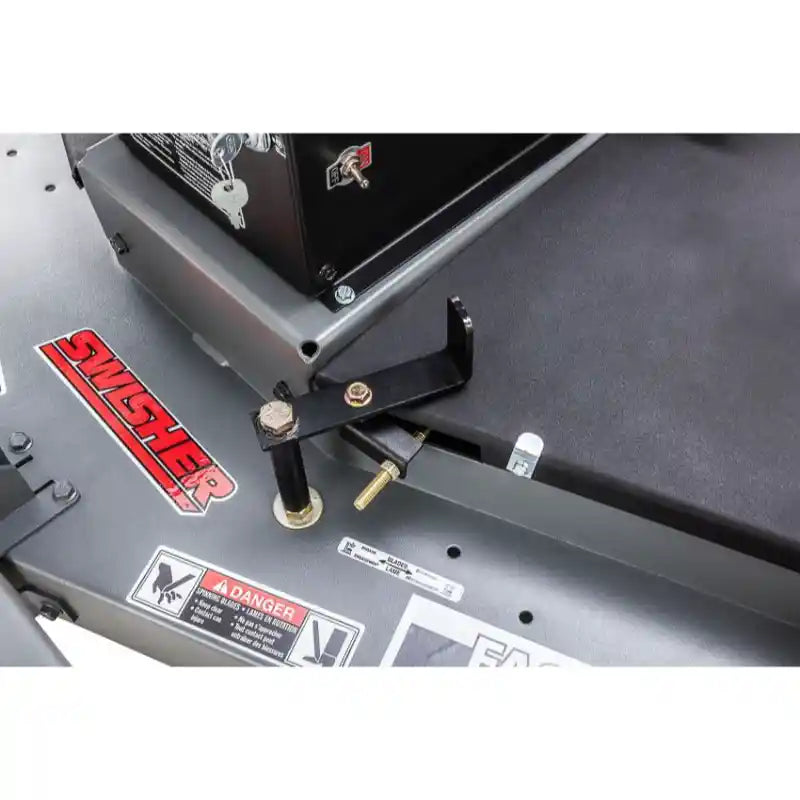 Close-up of tow-behind hitch adjustment mechanism and safety labels on Swisher 60-inch finish cut mower, gallery position 1