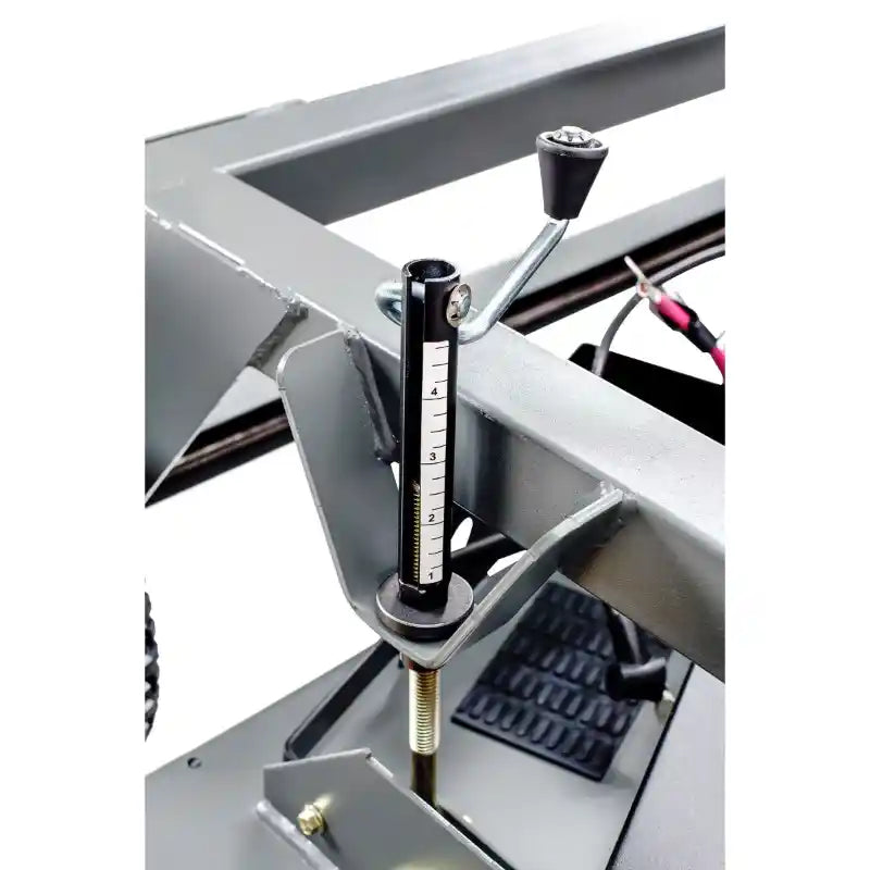 Close-up of height adjustment gauge with numbered scale and locking lever on Swisher 66-inch finish cut mower, gallery position 1