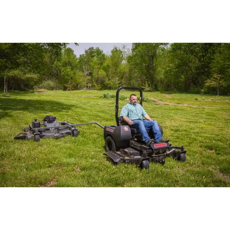 Swisher mower with 14.5HP engine towing 66-inch finish cut mower attachment on grass, gallery position 1