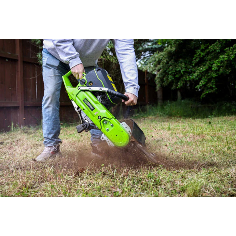 Operator holding GeoRipper GR727 Mini Trencher cutting a trench into grassy soil with green and black housing gallery position 1