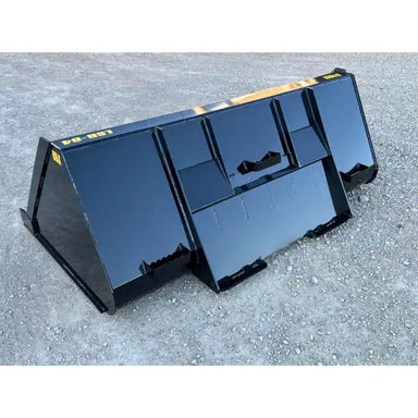 Triangular black steel liquid slurry bucket attachment resting on gravel surface outdoors