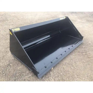Black steel skid steer material bucket with smooth cutting edge and welded side panels on dirt surface