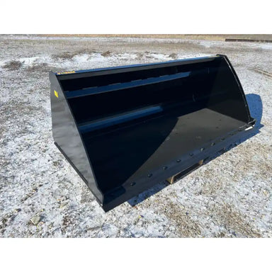Front-right view of large black steel material bucket attachment with smooth edges resting on gravel surface