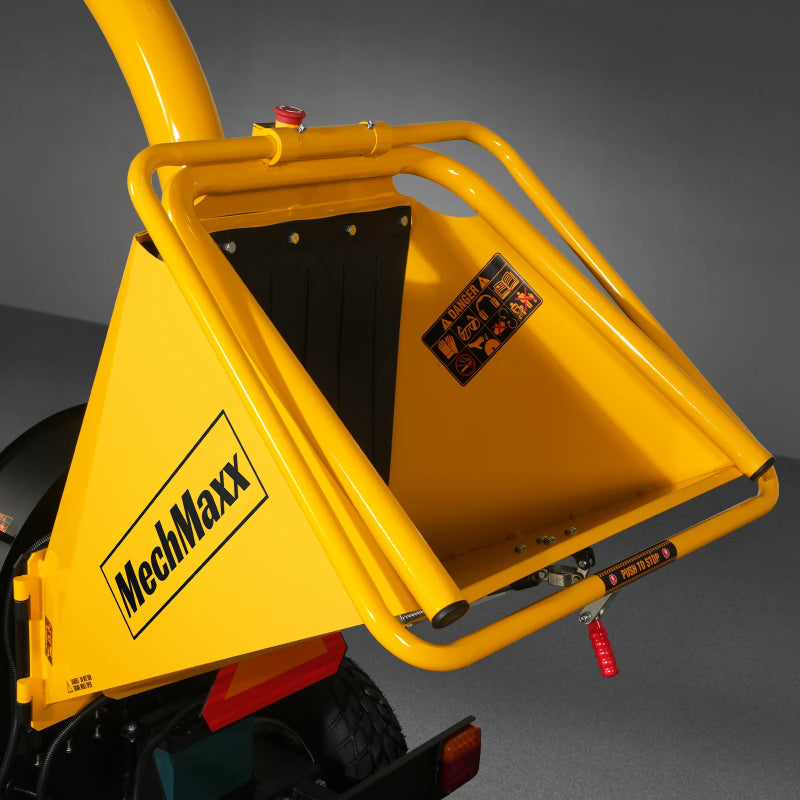 Close-up of MechMaxx P4205 5-inch gas wood chipper feed chute with safety guard and warning labels, gallery position 1