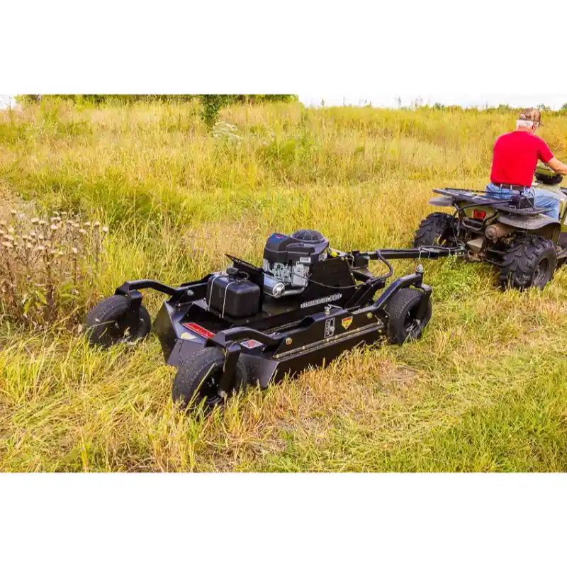 Tow-behind Swisher 44" Brush King mower with 14.5HP Kawasaki engine attached to ATV in field, gallery position 1