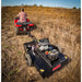 Swisher 44-inch rough cut brush cutter attached to ATV, clearing dry grass in open field, gallery position 1 view