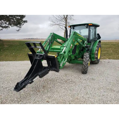 Stinger Attachments STP Tractor Tree Puller mounted on green tractor, gravel ground, square image gallery position 4