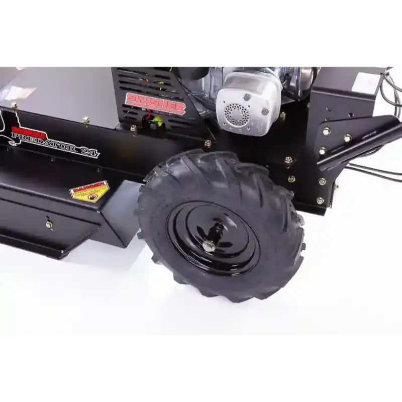 Close-up of front left wheel and engine housing on Swisher 24-inch walk-behind rough cut mower, gallery position 1