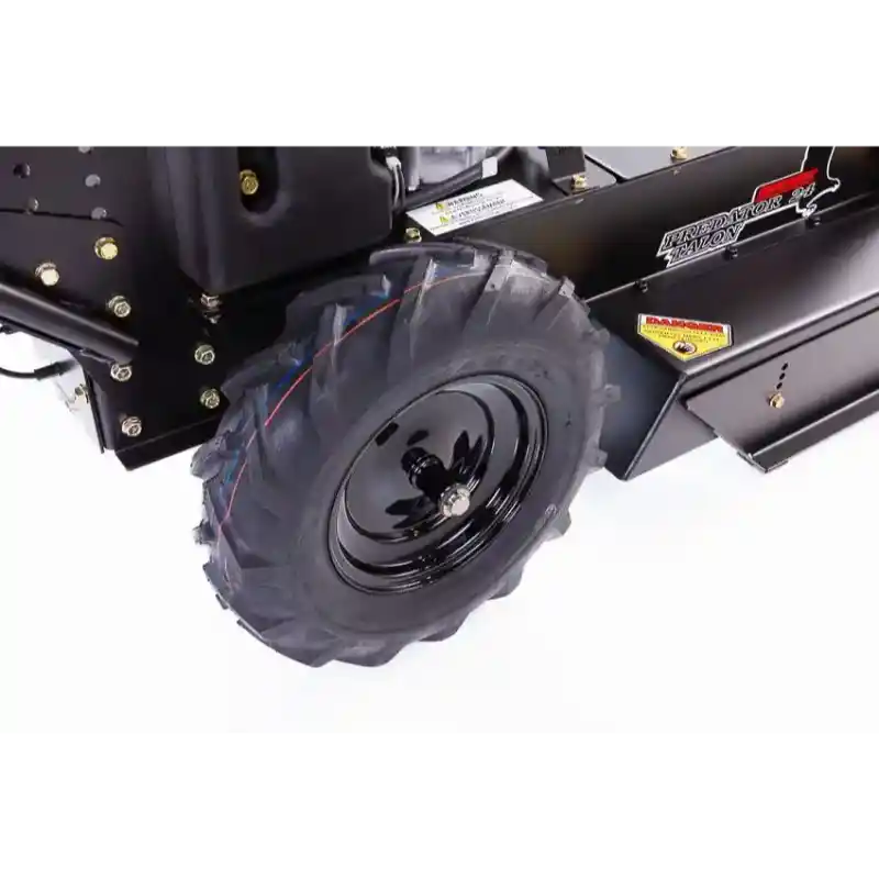 Close-up of rear traction tire and mower deck on Swisher 24-inch walk-behind rough cut mower, gallery position 1