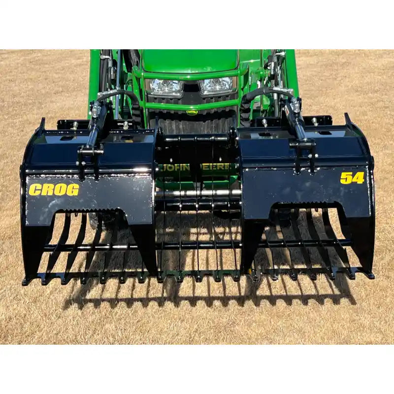 Black steel rock grapple attachment with wide spaced tines and dual hydraulic arms on grass field