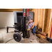 Man placing log on Swisher 22-Ton Timber Brute Eco Split electric log splitter indoors, gallery position 1