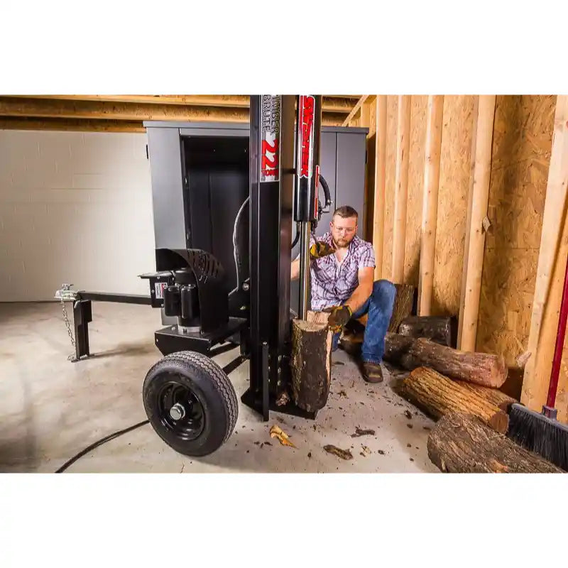 Man placing log on Swisher 22-Ton Timber Brute Eco Split electric log splitter indoors, gallery position 1