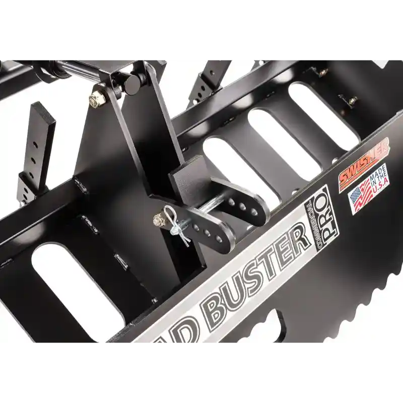 Close-up of Swisher Roadbuster Pro driveway grader blade assembly with adjustable mounting bracket and safety pin, gallery position 1