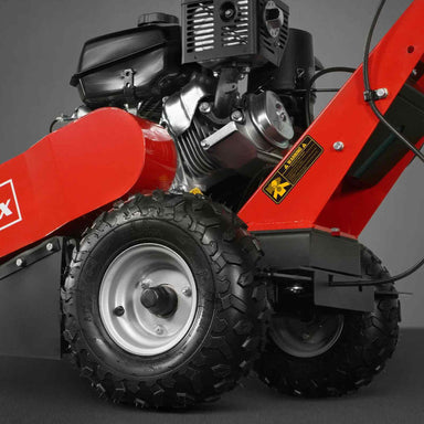 Close-up of tire and engine components on red MechMaxx 429cc KOHLER E-Start stump grinder, gallery position 1