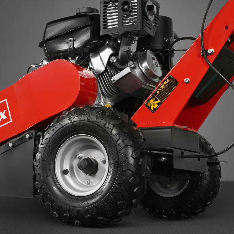 Close-up of tire and engine components on red MechMaxx 429cc KOHLER E-Start stump grinder, gallery position 1