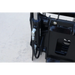 Close-up of black hydraulic cylinder and hoses connected to steel mounting bracket on concrete surface