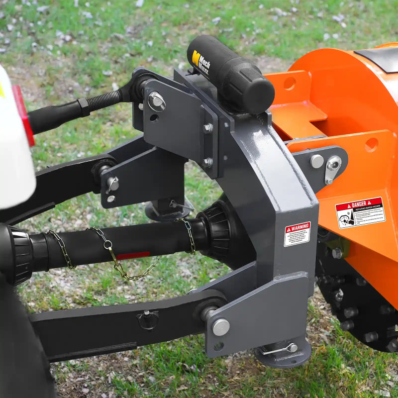 close-up of gray 3-point hitch mount and PTO shaft connection on orange MechMaxx SG30PRO stump grinder at gallery position 1