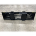 Wide black steel skid steer rock bucket attachment with spaced vertical tines and reinforced back plates on concrete floor