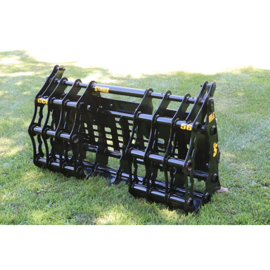 Black steel compact grapple attachment with reinforced bars and pivot points sitting on grass outdoors