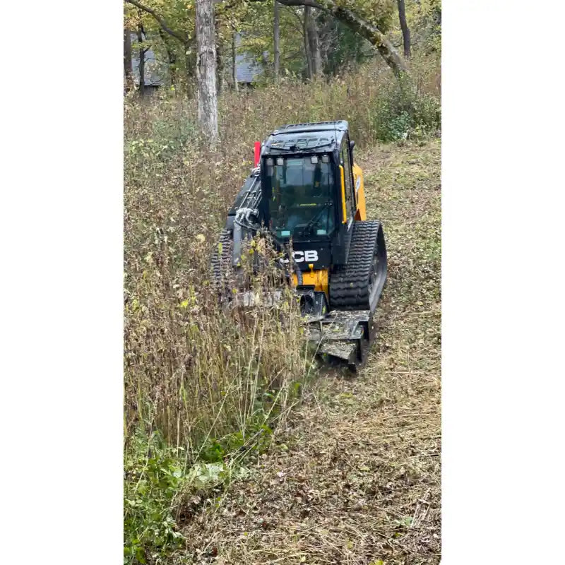 Skid steer with Stinger Attachments TF4 Twister brush cutter clearing dense brush in a wooded area, gallery image 10