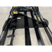 Close-up of black steel land plane skid steer attachment auger with welded blades and reinforced frame on concrete floor