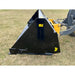 Left side view of black steel hydraulic dump bucket attachment connected to tractor loader arm on grass field