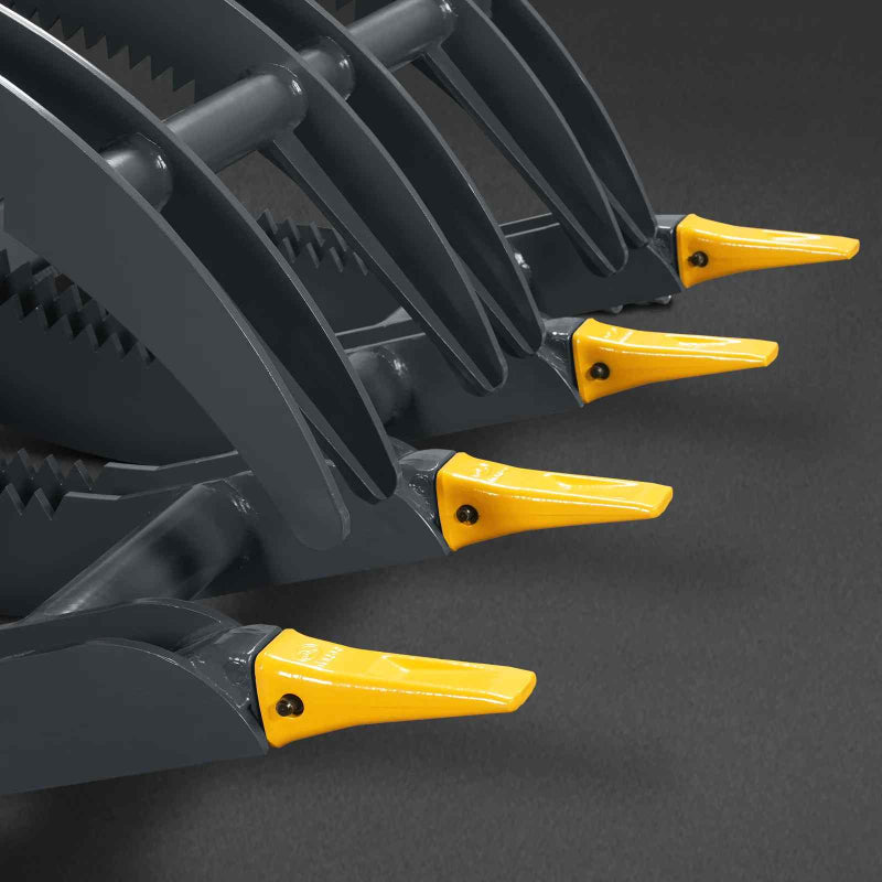 close-up angled view of black mini skid steer timber grab serrated tines with yellow replaceable tips gallery position 1