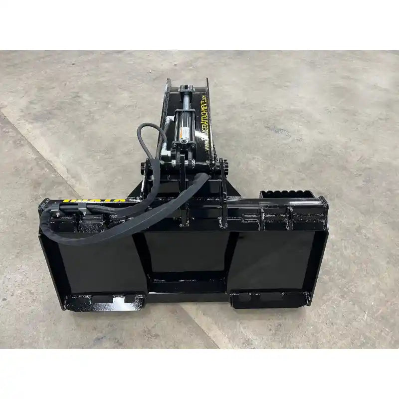 Black steel skid steer stump bucket grapple attachment with hydraulic cylinder and reinforced mounting frame on concrete floor