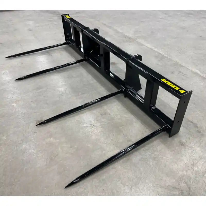 Black metal skid steer attachment with four long pointed tines on concrete floor labeled Series A