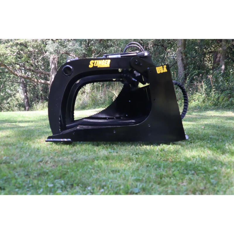 Left side view of black metal skid steer grapple attachment with curved arms, hydraulic hose, and Stinger decal on grass background