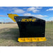 Side view of black and yellow steel snow pusher blade with bolt-on cutting edge resting on grass field