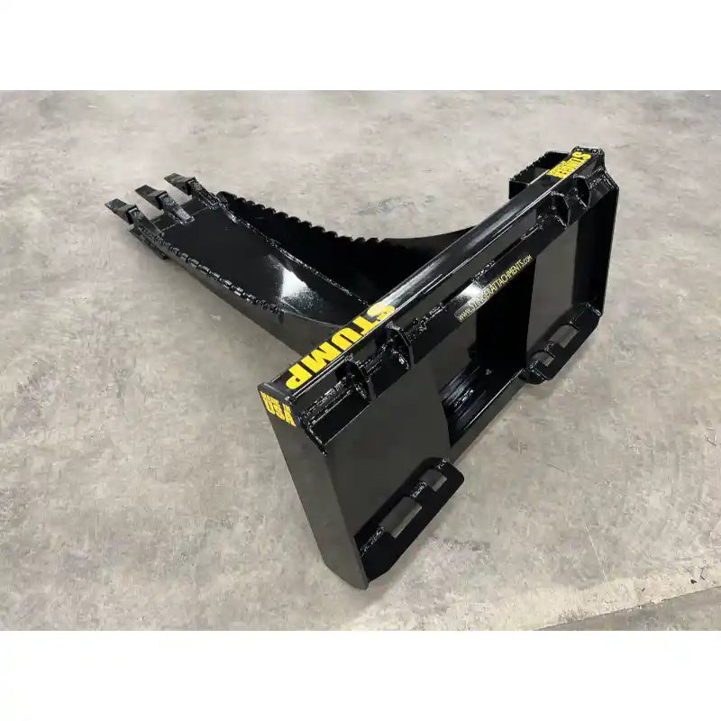 Black steel skid steer stump bucket attachment with three digging teeth and heavy welded frame on concrete floor indoors