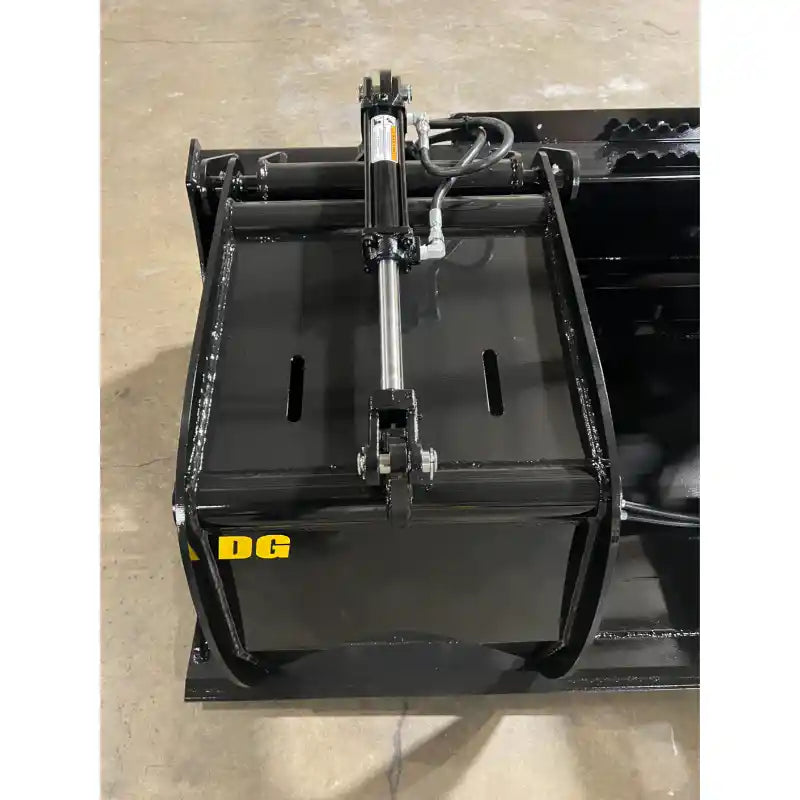 Front view of black steel grapple bucket attachment showing hydraulic cylinder and mounting plate on concrete floor