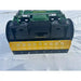 Yellow and black steel snow pusher attachment mounted on green John Deere skid steer loader over snow-covered ground