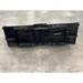 Black steel loader bucket attachment with reinforced edges and serrated cutting teeth on concrete floor