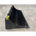 Side view of black skid steer rock bucket attachment with curved tines and solid side panels on concrete floor