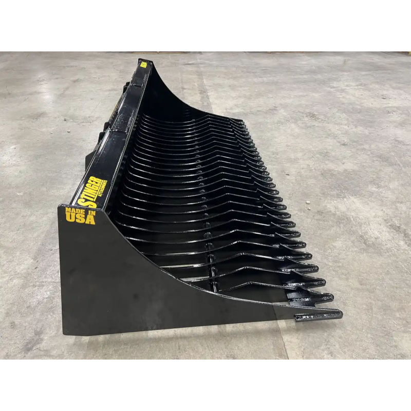 Side view of black skid steer rock bucket attachment with curved tines and solid side panels on concrete floor