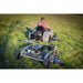 Rear view of operator riding mower towing Swisher 60-inch Finish Cut Mower with 15.5HP engine, gallery position 1