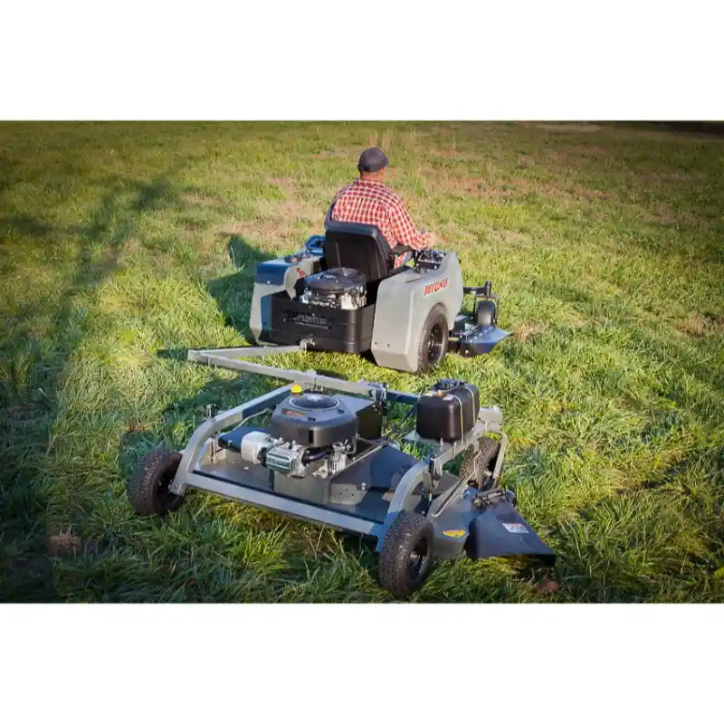 Rear view of operator riding mower towing Swisher 60-inch Finish Cut Mower with 15.5HP engine, gallery position 1