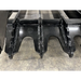 Black steel grapple attachment teeth with reinforced welds and structural crossbars on a concrete floor surface