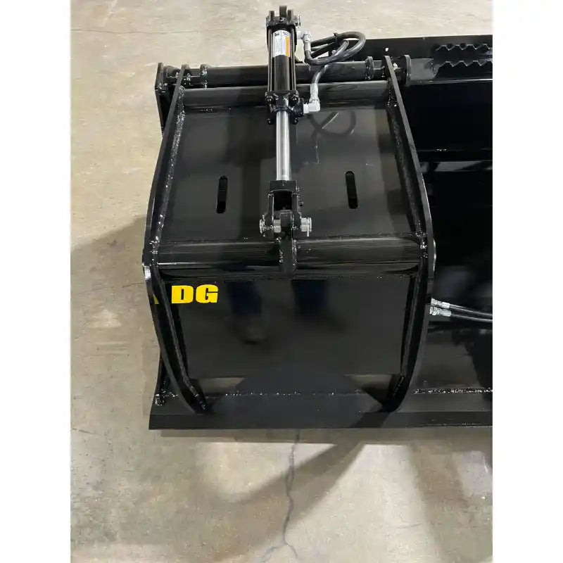 Black steel grapple bucket attachment with single hydraulic cylinder and clamp arms on concrete floor indoors