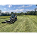 Skid steer with Stinger Attachments TF5 Twister brush cutter clearing tall grass in a wide open field gallery position 2