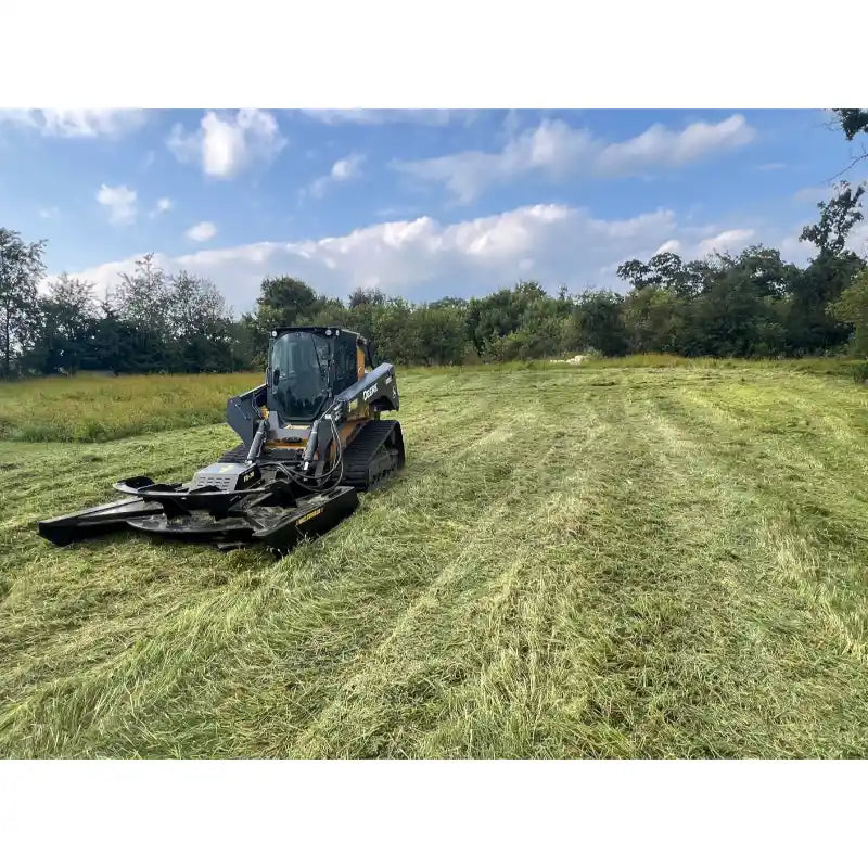 Skid steer with Stinger Attachments TF5 Twister brush cutter clearing tall grass in a wide open field gallery position 2