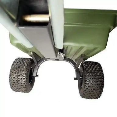 Underside view of green Swisher 16 cu ft poly tow-behind cart with rugged tread tires, gallery position 1
