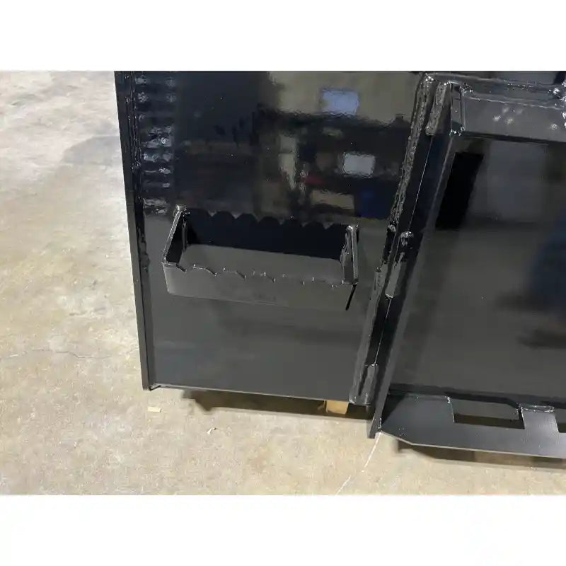 Black steel attachment with serrated clamp teeth and hinge on smooth concrete floor indoors