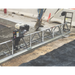 MBW Modular Vibratory Truss Screed with Honda GX160 engine leveling concrete on construction site, gallery position 1