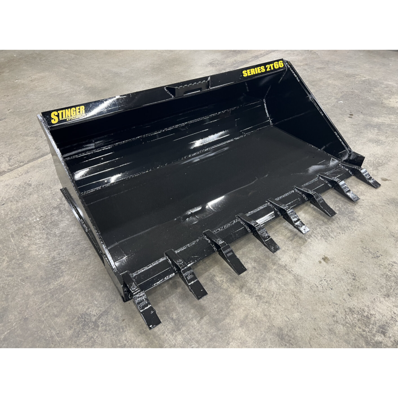 Black steel loader bucket attachment with nine tapered teeth and reinforced edges on concrete floor