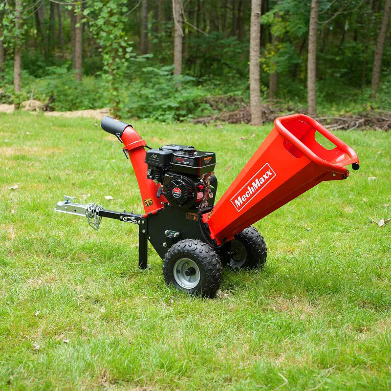 Red MechMaxx GS650 7hp gas wood chipper with towbar and large pneumatic tires on grass outdoors, gallery position 1 view