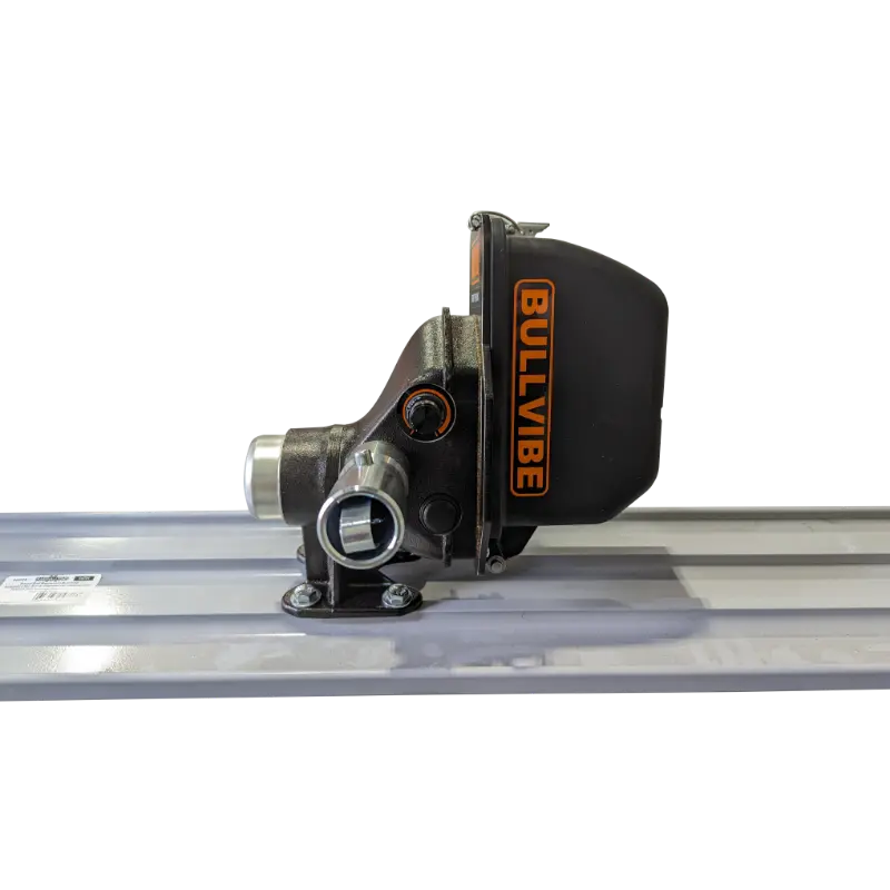 Side profile of black mechanical concrete bull float vibrator attachment mounted on aluminum screed rail